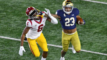 Oct 23, 2021; South Bend, Indiana, USA; Notre Dame Fighting Irish running back Kyren Williams (23) runs the ball as USC Trojans cornerback Isaac Taylor-Stuart (6) defends in the first quarter at Notre Dame Stadium. Mandatory Credit: Matt Cashore-USA TODAY Sports