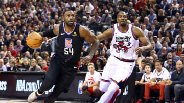 TORONTO, ON - DECEMBER 11: Patrick Patterson #54 of the Los Angeles Clippers dribbles the ball as Serge Ibaka #9 of the Toronto Raptors defends during the first half of an NBA game at Scotiabank Arena on December 11, 2019 in Toronto, Canada. NOTE TO USER: User expressly acknowledges and agrees that, by downloading and or using this photograph, User is consenting to the terms and conditions of the Getty Images License Agreement. (Photo by Vaughn Ridley/Getty Images)