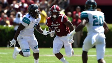 COLUMBIA, SC - SEPTEMBER 01: Rico Dowdle #5 of the South Carolina Gamecocks runs with the ball against Tarron Jackson #9 of the Coastal Carolina Chanticleers at Williams-Brice Stadium on September 1, 2018 in Columbia, South Carolina. SC won 49-15. (Photo by Lance King/Getty Images)