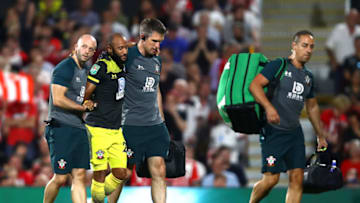 LONDON, ENGLAND - AUGUST 27: Nathan Redmond of Southampton is helped off the pitch after picking up an injury during the Carabao Cup Second Round match between Fulham and Southampton at Craven Cottage on August 27, 2019 in London, England. (Photo by Julian Finney/Getty Images)