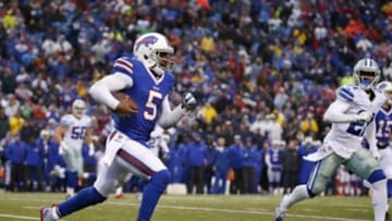 Dec 27, 2015; Orchard Park, NY, USA; Buffalo Bills quarterback Tyrod Taylor (5) runs with the ball for a first down during the second half against the Dallas Cowboys at Ralph Wilson Stadium. The Bills defeat Cowboys 16-6. Mandatory Credit: Kevin Hoffman-USA TODAY Sports