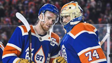 EDMONTON, CANADA - OCTOBER 29: Connor McDavid #97 (L) and Stuart Skinner #74 of the Edmonton Oilers celebrate after defeating the Calgary Flames during the third period of the 2023 Tim Hortons NHL Heritage Classic at Commonwealth Stadium on October 29, 2023 in Edmonton, Alberta, Canada. The Oilers defeated the Flames 5-2. (Photo by Derek Leung/Getty Images)