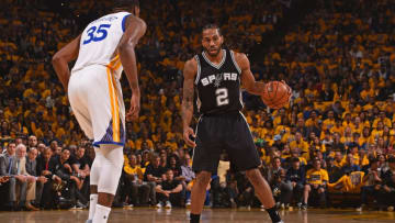 OAKLAND, CA - MAY 14: Kawhi Leonard #2 of the San Antonio Spurs dribbles the ball while guarded by Kevin Durant #35 of the Golden State Warriors in Game One of the Western Conference Finals during the 2017 NBA Playoffs on May 14, 2017 at ORACLE Arena in Oakland, California. NOTE TO USER: User expressly acknowledges and agrees that, by downloading and or using this photograph, user is consenting to the terms and conditions of Getty Images License Agreement. Mandatory Copyright Notice: Copyright 2017 NBAE (Photo by Noah Graham/NBAE via Getty Images)