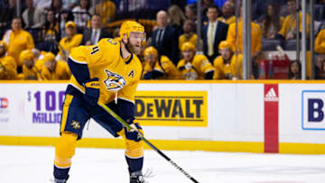 NASHVILLE, TN - FEBRUARY 21: Mattias Ekholm #14 of the Nashville Predators controls the puck against the Vancouver Canucks during the first period at Bridgestone Arena on February 21, 2023 in Nashville, Tennessee. (Photo by Brett Carlsen/Getty Images)