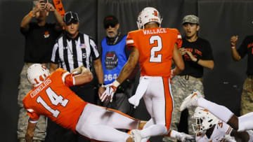 STILLWATER, OK - OCTOBER 27: Quarterback Taylor Cornelius #14 of the Oklahoma State Cowboys dives across the pylon to score the game-winning touchdown against linebacker Gary Johnson #33 of the Texas Longhorns late in the fourth quarter on October 27, 2018 at Boone Pickens Stadium in Stillwater, Oklahoma. Oklahoma State won 38-35. (Photo by Brian Bahr/Getty Images)