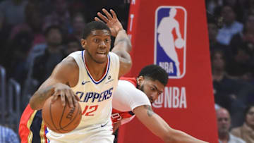 LOS ANGELES, CA - APRIL 09: Tyrone Wallace #12 of the Los Angeles Clippers grabs a rebound against Anthony Davis #23 of the New Orleans Pelicans in the first half of the game at Staples Center on April 9, 2018 in Los Angeles, California. NOTE TO USER: User expressly acknowledges and agrees that, by downloading and or using this photograph, User is consenting to the terms and conditions of the Getty Images License Agreement. (Photo by Jayne Kamin-Oncea/Getty Images)