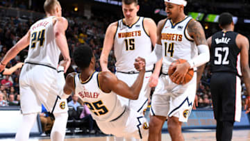 DENVER, CO - MARCH 31: Malik Beasley #25 of the Denver Nuggets is helped up by his teammates during the game against the Washington Wizards on March 31, 2019 at the Pepsi Center in Denver, Colorado. NOTE TO USER: User expressly acknowledges and agrees that, by downloading and/or using this photograph, user is consenting to the terms and conditions of the Getty Images License Agreement. Mandatory Copyright Notice: Copyright 2019 NBAE (Photo by Garrett Ellwood/NBAE via Getty Images)