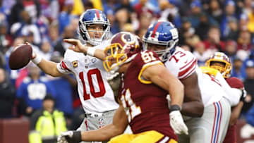 Nov 29, 2015; Landover, MD, USA; New York Giants quarterback Eli Manning (10) throws the ball as Washington Redskins outside linebacker Ryan Kerrigan (91) chases in the third quarter at FedEx Field. The Redskins won 20-14. Mandatory Credit: Geoff Burke-USA TODAY Sports