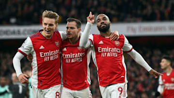 Arsenal's Norwegian midfielder Martin Odegaard (L) and Arsenal's German-born Portuguese defender Cedric Soares (C)congratulate goalscorer Arsenal's French striker Alexandre Lacazette during the English Premier League football match between Arsenal and Leicester City at the Emirates Stadium in London on March 13, 2022. - - RESTRICTED TO EDITORIAL USE. No use with unauthorized audio, video, data, fixture lists, club/league logos or 'live' services. Online in-match use limited to 120 images. An additional 40 images may be used in extra time. No video emulation. Social media in-match use limited to 120 images. An additional 40 images may be used in extra time. No use in betting publications, games or single club/league/player publications. (Photo by Glyn KIRK / AFP) / RESTRICTED TO EDITORIAL USE. No use with unauthorized audio, video, data, fixture lists, club/league logos or 'live' services. Online in-match use limited to 120 images. An additional 40 images may be used in extra time. No video emulation. Social media in-match use limited to 120 images. An additional 40 images may be used in extra time. No use in betting publications, games or single club/league/player publications. / RESTRICTED TO EDITORIAL USE. No use with unauthorized audio, video, data, fixture lists, club/league logos or 'live' services. Online in-match use limited to 120 images. An additional 40 images may be used in extra time. No video emulation. Social media in-match use limited to 120 images. An additional 40 images may be used in extra time. No use in betting publications, games or single club/league/player publications. (Photo by GLYN KIRK/AFP via Getty Images)