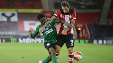 SOUTHAMPTON, ENGLAND - JULY 16: Tariq Lamptey of Brighton & Hove Albion closes down Danny Ings of Southampton during the Premier League match between Southampton FC and Brighton & Hove Albion at St Mary's Stadium on July 16, 2020 in Southampton, England. Football Stadiums around Europe remain empty due to the Coronavirus Pandemic as Government social distancing laws prohibit fans inside venues resulting in all fixtures being played behind closed doors. (Photo by Robin Jones/Getty Images)