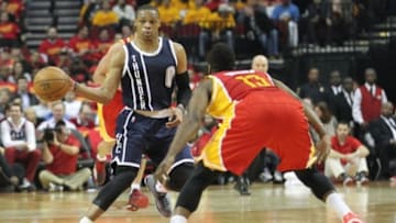 Jan 15, 2015; Houston, TX, USA; Oklahoma City Thunder guard Russell Westbrook (0) passes the ball around Houston Rockets guard James Harden (13) in the second quarter at Toyota Center. Mandatory Credit: Thomas B. Shea-USA TODAY Sports