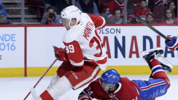 Mar 29, 2016; Montreal, Quebec, CAN; Detroit Red Wings forward Anthony Mantha (39) plays the puck and Montreal Canadiens defenseman Alexei Emelin (74) defends during the third period at the Bell Centre. Mandatory Credit: Eric Bolte-USA TODAY Sports