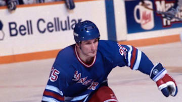 TORONTO, ON - MARCH 14: John Ogrodnick #25 of the New York Rangers skates against the Toronto Maple Leafs during NHL game action March 14, 1990 at Maple Leaf Gardens in Toronto, Ontario, Canada. New York defeated Toronto 8-2. (Photo by Graig Abel/Getty Images)