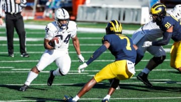 Penn State running back Keyvone Lee (24) runs against Michigan defensive back Makari Paige (7) during the first half at Michigan Stadium in Ann Arbor, Saturday, Nov. 28, 2020.