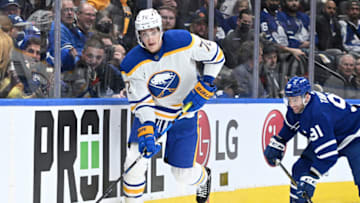 Apr 12, 2022; Toronto, Ontario, CAN; Buffalo Sabres forward Tage Thompson (72) skates the puck away from Toronto Maple Leafs forward John Tavares (91) in the first period at Scotiabank Arena. Mandatory Credit: Dan Hamilton-USA TODAY Sports