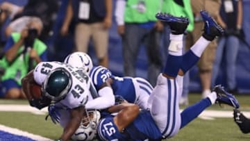 Sep 15, 2014; Indianapolis, IN, USA; Philadelphia Eagles running back Darren Sproles (43) scores a touchdown as he breaks a tackle by Indianapolis Colts linebacker Josh McNary (57) at Lucas Oil Stadium. Mandatory Credit: Brian Spurlock-USA TODAY Sports