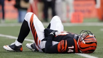 Dec 7, 2014; Cincinnati, OH, USA; Cincinnati Bengals quarterback Andy Dalton (14) is slow to get up after being tackled against the Pittsburgh Steelers at Paul Brown Stadium. The Steelers won 42-21. Mandatory Credit: Aaron Doster-USA TODAY Sports