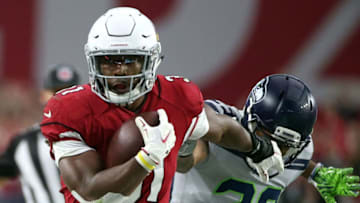 GLENDALE, AZ - SEPTEMBER 30: Running back David Johnson #31 of the Arizona Cardinals stiff arms defensive back Earl Thomas #29 of the Seattle Seahawks during the second quarter at State Farm Stadium on September 30, 2018 in Glendale, Arizona. (Photo by Ralph Freso/Getty Images)