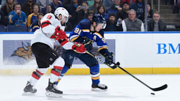 ST. LOUIS, MO - FEBRUARY 12: Will Butcher #8 of the New Jersey Devils and Vladimir Tarasenko #91 of the St. Louis Blues battle for the puck at Enterprise Center on February 12, 2019 in St. Louis, Missouri. (Photo by Joe Puetz/NHLI via Getty Images)