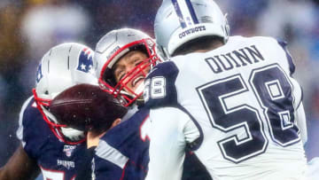 FOXBOROUGH, MA - NOVEMBER 24: Tom Brady #12 of the New England Patriots is tackled by Robert Quinn #58 of the Dallas Cowboys during a game at Gillette Stadium on November 24, 2019 in Foxborough, Massachusetts. (Photo by Adam Glanzman/Getty Images)