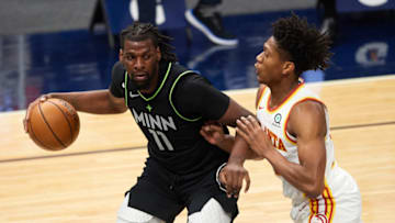 De'Andre Hunter of the Atlanta Hawks defends against Naz Reid of the Minnesota Timberwolves. (Photo by Hannah Foslien/Getty Images)