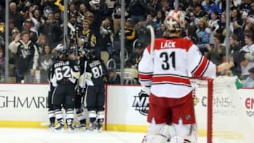 Jan 17, 2016; Pittsburgh, PA, USA; The Pittsburgh Penguins celebrate a goal by Pittsburgh Penguins defenseman Olli Maatta (hidden) as Carolina Hurricanes goalie Eddie Lack (31) reacts during the first period at the CONSOL Energy Center. Mandatory Credit: Charles LeClaire-USA TODAY Sports