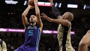 Nov 7, 2015; San Antonio, TX, USA; Charlotte Hornets small forward Nicolas Batum (5) shoots the ball as San Antonio Spurs power forward David West (R) defends during the second half at AT&T Center. Mandatory Credit: Soobum Im-USA TODAY Sports