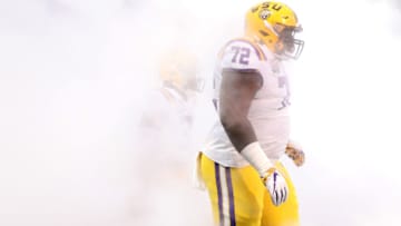 Dec 28, 2019; Atlanta, Georgia, USA; LSU Tigers nose tackle Tyler Shelvin (72) runs out through the fog before the 2019 Peach Bowl college football playoff semifinal game between the LSU Tigers and the Oklahoma Sooners at Mercedes-Benz Stadium. Mandatory Credit: Jason Getz-USA TODAY Sports