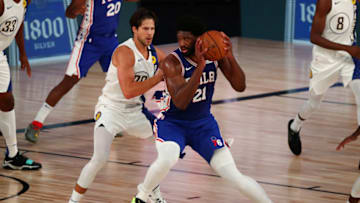 Kansas basketball alum Joel Embiid of the Philadelphia 76ers handles the ball against Doug McDermott. (Photo by Kim Klement - Pool/Getty Images)