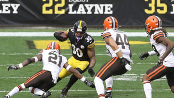 Oct 18, 2020; Pittsburgh, Pennsylvania, USA; Pittsburgh Steelers running back James Conner (30) runs the ball against Cleveland Browns cornerback Denzel Ward (21) and linebacker Sione Takitaki (44) during the first quarter at Heinz Field. Mandatory Credit: Charles LeClaire-USA TODAY Sports