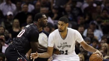 Mar 6, 2014; San Antonio, TX, USA; San Antonio Spurs forward Tim Duncan (21) is defended by Miami Heat center Greg Oden (20) during the first half at AT&T Center. Mandatory Credit: Soobum Im-USA TODAY Sports