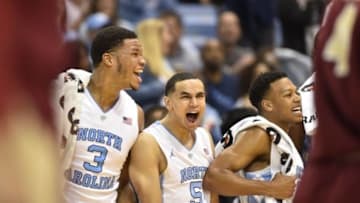 Jan 30, 2016; Chapel Hill, NC, USA; North Carolina Tar Heels forward Kennedy Meeks (3) and guard Marcus Paige (5) and guard Nate Britt (0) react at the end of the game. The Tar Heels defeated the Eagles 89-62 at Dean E. Smith Center. Mandatory Credit: Bob Donnan-USA TODAY Sports