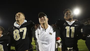 ORLANDO, FL - NOVEMBER 24: Head coach Scott Frost of the UCF Knights celebrates with his team after a game against the South Florida Bulls at Spectrum Stadium on November 24, 2017 in Orlando, Florida. UCF Knights defeated South Florida Bulls 49-42. (Photo by Logan Bowles/Getty Images)