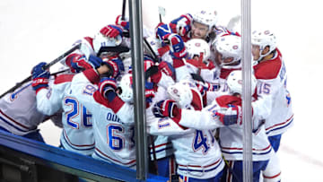 TORONTO, ONTARIO - AUGUST 01: The Montreal Canadiens surround teammate Jeff Petry #26 after he scored the game winning goal in overtime against the Pittsburgh Penguins during Game One of the Eastern Conference Qualification Round prior to the 2020 NHL Stanley Cup Playoffs at Scotiabank Arena on August 01, 2020 in Toronto, Ontario. (Photo by Andre Ringuette/Freestyle Photo/Getty Images)