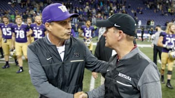 SEATTLE, WA - SEPTEMBER 09: Head coach Chris Petersen (L) of the Washington Huskies is congratulated by head coach Bob Stitt of the Montana Grizzlies after the Huskies defeated the Grizzlies 63-7 at Husky Stadium on September 9, 2017 in Seattle, Washington. (Photo by Otto Greule Jr/Getty Images)