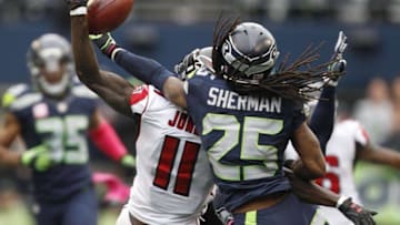 Oct 16, 2016; Seattle, WA, USA; Seattle Seahawks cornerback Richard Sherman (25) defends a pass intended for Atlanta Falcons wide receiver Julio Jones (11) during the fourth quarter at CenturyLink Field. Seattle defeated Atlanta, 26-24. Mandatory Credit: Joe Nicholson-USA TODAY Sports