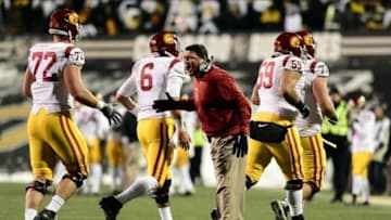 Nov 23, 2013; Boulder, CO, USA; Southern California Trojans interim head coach Ed Orgeron congratulates offensive tackle Chad Wheeler (72) and quarterback Cody Kessler (6) and guard John Martinez (59) and and offensive tackle Kevin Graf (77) after a touchdown drive in the second quarter against the Colorado Buffaloes at Folsom Field. Mandatory Credit: Ron Chenoy-USA TODAY Sports