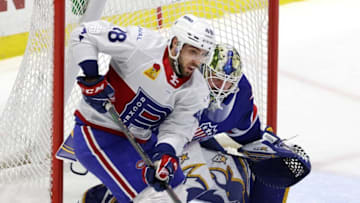 Laval's Peter Abbandonato tries to screen Amerks goalie Aaron Dell.