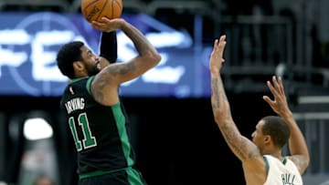 MILWAUKEE, WISCONSIN - APRIL 28: Kyrie Irving #11 of the Boston Celtics attempts a shot while being guarded by George Hill #3 of the Milwaukee Bucks in the fourth quarter during Game One of Round Two of the 2019 NBA Playoffs at the Fiserv Forum on April 28, 2019 in Milwaukee, Wisconsin. NOTE TO USER: User expressly acknowledges and agrees that, by downloading and or using this photograph, User is consenting to the terms and conditions of the Getty Images License Agreement. (Photo by Dylan Buell/Getty Images)