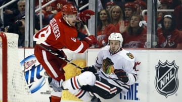 May 23, 2013; Detroit, MI, USA; Detroit Red Wings left wing Justin Abdelkader (8) checks Chicago Blackhawks defenseman Niklas Hjalmarsson (4) in the third period in game four of the second round for the 2013 Stanley Cup Playoffs at Joe Louis Arena. Detroit won 2-0. Mandatory Credit: Rick Osentoski-USA TODAY Sports