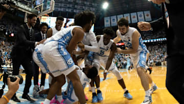 CHAPEL HILL, NC - FEBRUARY 09: Players of the North Carolina Tar Heels help up teammate Brandon Robinson #4 while celebrating their 88-85 OT win against the Miami Hurricanes at Dean Smith Center on February 9, 2019 in Chapel Hill, North Carolina. (Photo by Lance King/Getty Images)