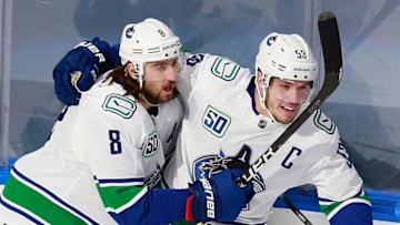 EDMONTON, ALBERTA - AUGUST 14: Bo Horvat #53 of the Vancouver Canucks (R) scores a shorthanded goal at 7:23 of the first period against the St. Louis Blues and is joined by Christopher Tanev #8 (L) in Game Two of the Western Conference First Round during the 2020 NHL Stanley Cup Playoffs at Rogers Place on August 14, 2020 in Edmonton, Alberta, Canada. (Photo by Jeff Vinnick/Getty Images)