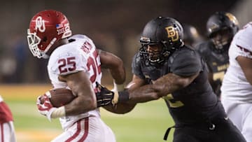 Nov 14, 2015; Waco, TX, USA; Oklahoma Sooners running back Joe Mixon (25) tries to elude Baylor Bears defensive end Shawn Oakman (2) during the game at McLane Stadium. The Sooners defeat the Bears 44-34. Mandatory Credit: Jerome Miron-USA TODAY Sports