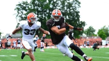 Jul 28, 2014; Berea, OH, USA; Cleveland Browns tight end Jordan Cameron (84) makes a catch while being defended by Jordan Poyer (33) during training camp at Cleveland Browns training facility. Mandatory Credit: Andrew Weber-USA TODAY Sports