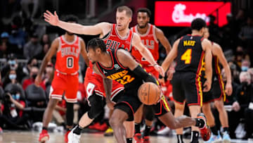 Dec 27, 2021; Atlanta, Georgia, USA; Atlanta Hawks forward Cam Reddish (22) dribbles past Chicago Bulls guard Matt Thomas (21) during the second half at State Farm Arena. Mandatory Credit: Dale Zanine-USA TODAY Sports