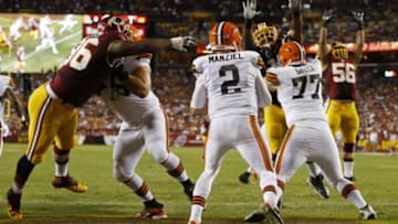 Aug 18, 2014; Landover, MD, USA; Cleveland Browns quarterback Johnny Manziel (2) scrambles with the ball in the end zone as Washington Redskins defensive tackle Barry Cofield (96) chases in the second quarter at FedEx Field. Mandatory Credit: Geoff Burke-USA TODAY Sports