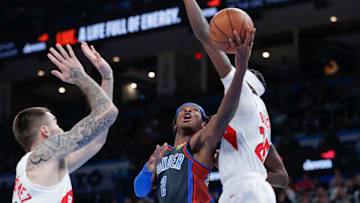 OKC Thunder guard Shai Gilgeous-Alexander (2) shoots b/t Raptors forward Chris Boucher (25) and forward Juancho Hernangomez (41) Alonzo Adams-USA TODAY Sports