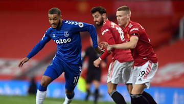 Everton's Norwegian striker Josh King (L) beats Manchester United's Portuguese midfielder Bruno Fernandes (C) and Manchester United's Scottish midfielder Scott McTominay during the English Premier League football match between Manchester United and Everton at Old Trafford in Manchester, north west England, on February 6, 2021. (Photo by Michael Regan / POOL / AFP) / RESTRICTED TO EDITORIAL USE. No use with unauthorized audio, video, data, fixture lists, club/league logos or 'live' services. Online in-match use limited to 120 images. An additional 40 images may be used in extra time. No video emulation. Social media in-match use limited to 120 images. An additional 40 images may be used in extra time. No use in betting publications, games or single club/league/player publications. / (Photo by MICHAEL REGAN/POOL/AFP via Getty Images)