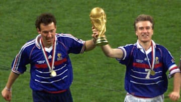 French captain Didier Deschamps (C) and Laurent Blanc (L) hold the FIFA trophy after the 1998 Soccer World Cup final between Brazil and France at Stade de France in Saint-Denis, near to Paris. France won 0-3. (ELECTRONIC IMAGE) AFP PHOTO THOMAS COEX (Photo credit should read THOMAS COEX/AFP/Getty Images)