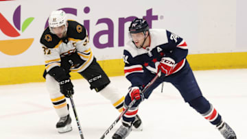 Apr 8, 2021; Washington, District of Columbia, USA; Boston Bruins center Patrice Bergeron (37) and Washington Capitals defenseman John Carlson (74) battle for the puck in the third period at Capital One Arena. Mandatory Credit: Geoff Burke-USA TODAY Sports